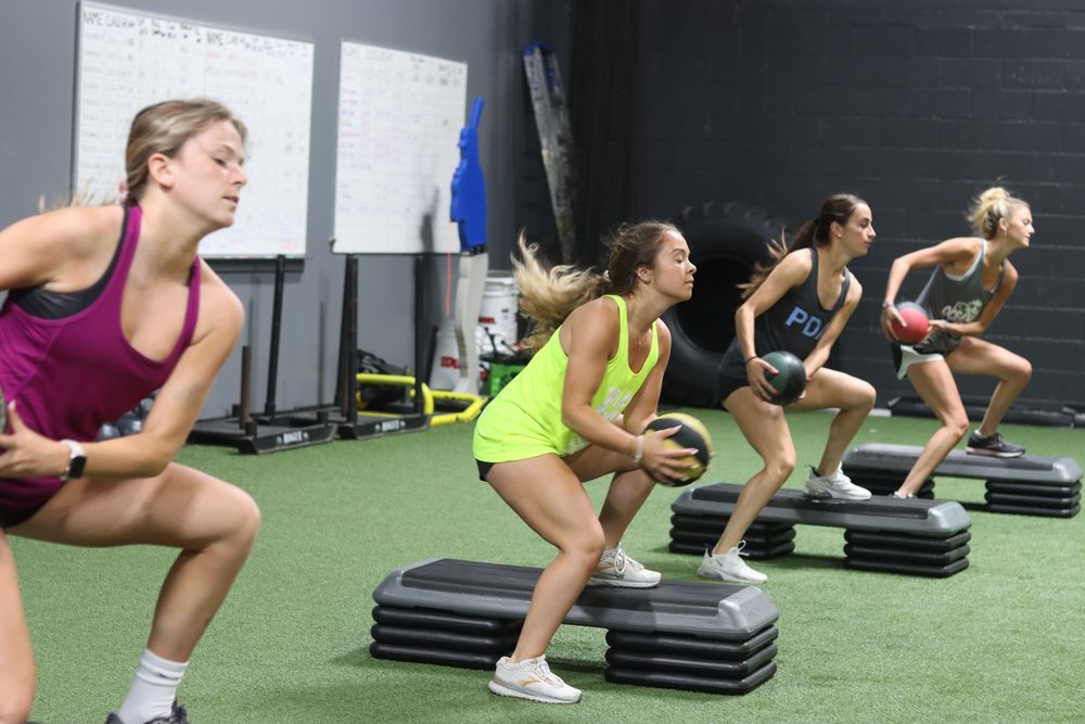 High school athletes training with med balls at Athletic Republic Escape